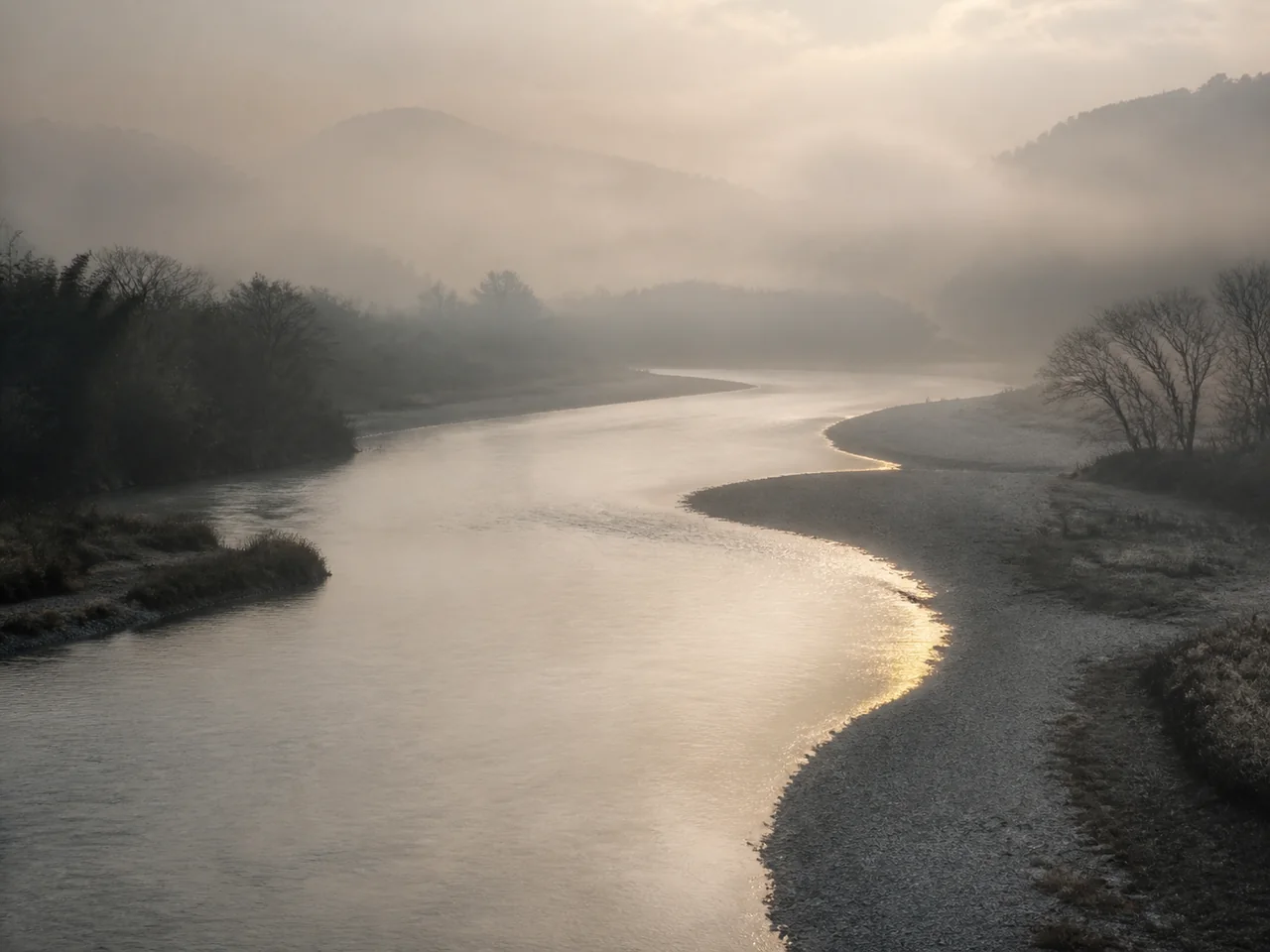 A river flowing through morning mist
